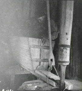 Man using the hopper in a mamsel mill in Laitila, Varsinais-Suomi