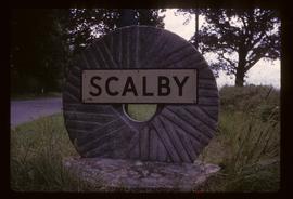 Village sign on millstone