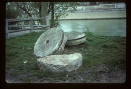 Pair of millstones lying by river
