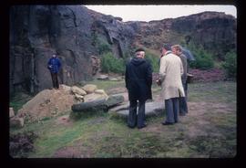 Group of people with millstones in quarry