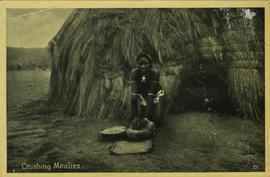 Women crushing mealies