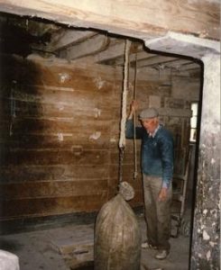 Photograph of John Murphy working the sack hoist, Redmond's Mill, Foulksmills, Wexford, Ireland