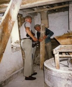 Photograph of Niall Roberts and John Murphy on the stone floor, Redmond's Mill, Foulksmills, Wexford
