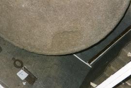 Photograph of a handgrip recess on a quernstone, Chedworth Roman Villa, Gloucestershire