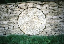 Photograph of a millstone in a wall, Slaughter Farm, Bourton on the Water, Gloucestershire