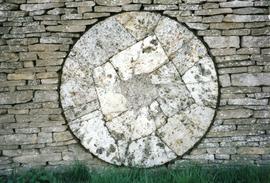 Photograph of a millstone in a wall, Slaughter Farm, Bourton on the Water, Gloucestershire