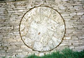 Photograph of a millstone in a wall, Slaughter Farm, Bourton on the Water, Gloucestershire