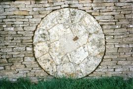 Photograph of a millstone in a wall, Slaughter Farm, Bourton on the Water, Gloucestershire