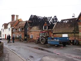 Exterior view of damage, with volunteers sweeping