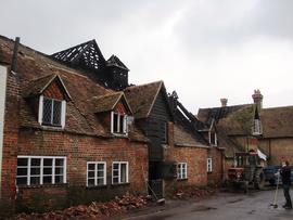 Exterior view of damage showing debris from roof