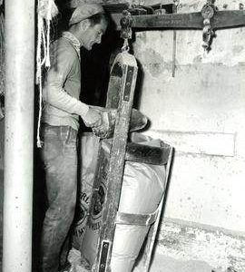 Mill worker weighing a filled sack, Burgh-next-Aylsham, Norfolk
