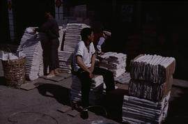 China. Long Zu. Wrapping up mulberry paper.