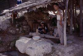 China. Long Zu. Man at stamper.