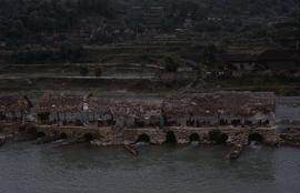 China. Chong-an Sawdust mills in river.