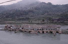 China, Chong-an. Sawdust mills in river.