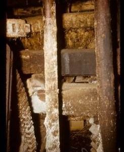Interior of watermill showing part of pit wheel and other gearing