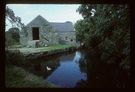 Exterior of watermill building by pond