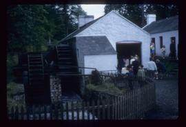 Exterior view of preserved watermill building with double wheel