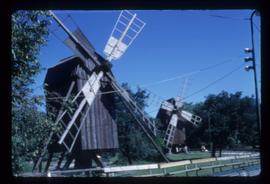 Pair of preserved open-trestle post mills with sails