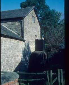 Exterior of watermill building with wheel