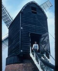 James Waterfield in doorway of buck of restored post mill