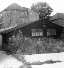 Buildings with mill base in background, wind, steam and water mill, Kennington
