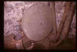 Fremington Mill, Devon, Grind stone leaning on wall