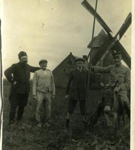 Russian and French soldiers pose next to a miller and his son