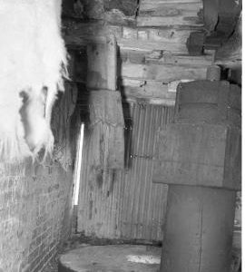 King's Bromley Flour Mill, King's Bromley - first floor, top of upright shaft and a pair of millstones, seen through a window in the front of the mill