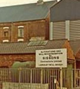 Langley Mills with sign by Sissons