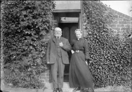 Miller and his wife outside their house
