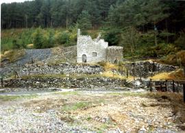 Dressing floor with two 20' buddles and a 6-compartment jigger driven by 18' x 3.5 wheel. Crushing house in background., Ysgubor-y-coed, Ystrad Einion, Cardiganshire